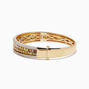The 14K Yellow Gold Multi Color Diamond Bangle showcases a row of round yellow, orange, and brown diamonds bordered by small white diamonds along the edges.