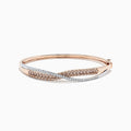The 14K Two Tone Gold Espresso and White Diamond Crossover Bangle, 2.00 TCW, features overlapping rose gold and silver-toned bands adorned with sparkling espresso and white diamonds, secured by a hinged clasp.