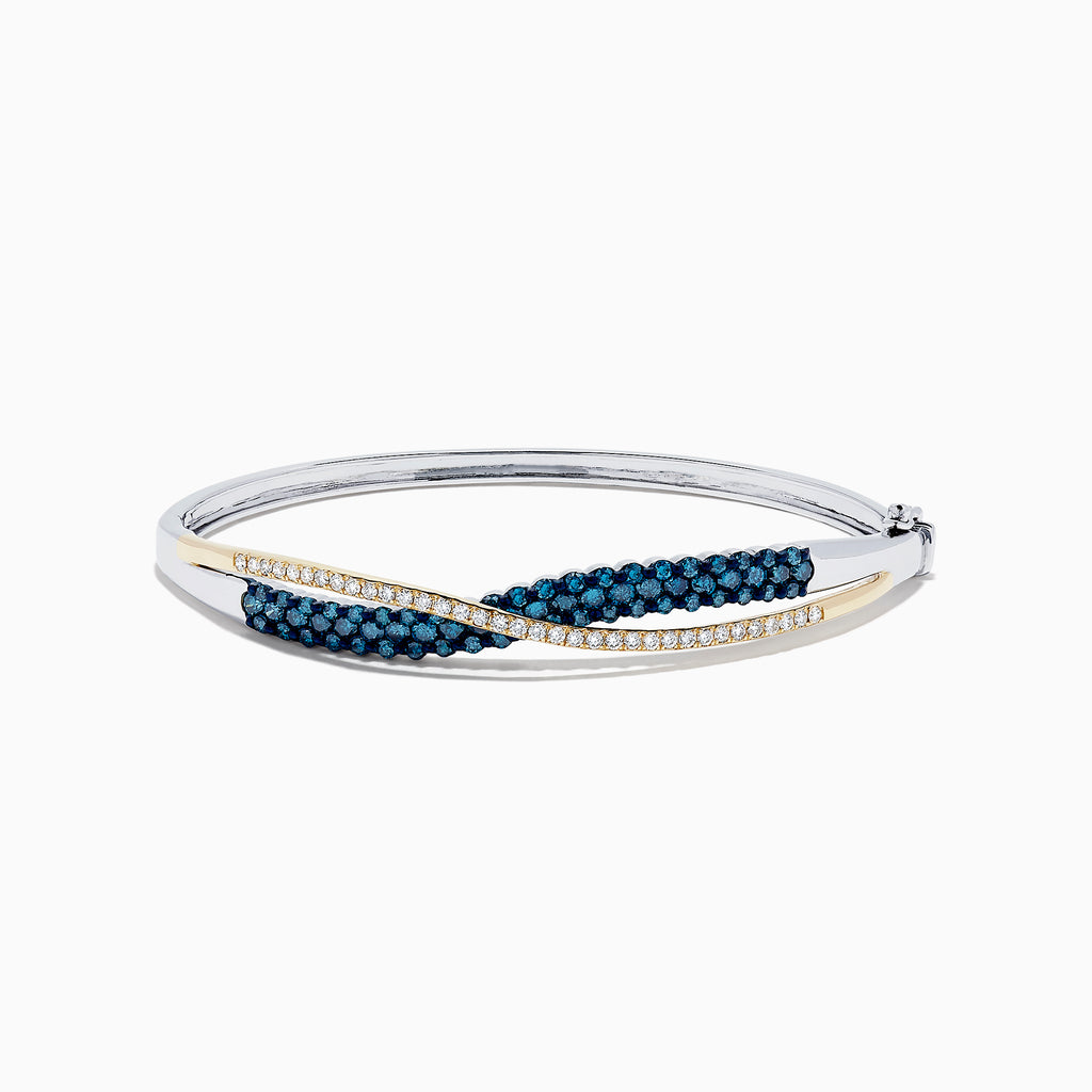 The 14K Two Tone Gold Blue and White Diamond Crossover Bangle, 2.00 TCW, features a gold-tone wave design accented with blue and white diamonds.