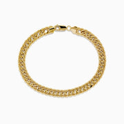 The 14K Two-Tone Yellow and White Gold Reversible Curb Chain Link Bracelet (9) features tightly linked flat curb chains and a secure clasp, shown arranged in a circle on a white background.