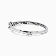 The Signature Sterling Silver Diamond and Tsavorite Panther Bangle, 0.10TCW, showcases a polished panther head detail and diamond-accented circular clasp, elegantly displayed on a white background.
