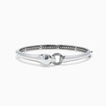 The Signature Sterling Silver Diamond and Tsavorite Panther Bangle, 0.10TCW, showcases a polished panther head detail and diamond-accented circular clasp, elegantly displayed on a white background.