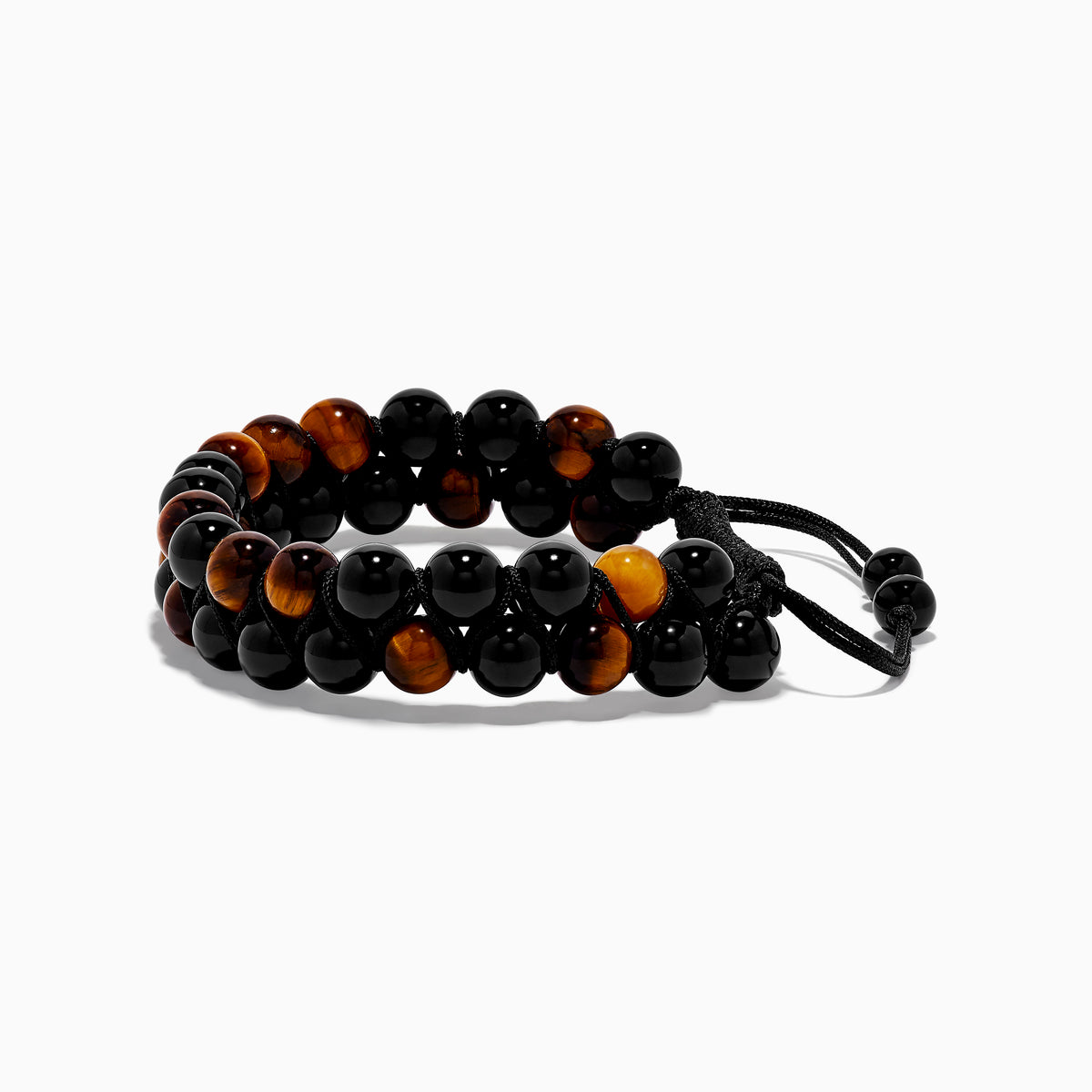 The Mens Tigers Eye Bead Bracelet features alternating glossy black and tiger’s eye brown beads, strung on a black braided adjustable cord. Stylish and versatile, its displayed on a white background—ideal for any occasion.