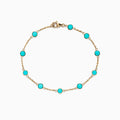 The 14K Yellow Gold Turquoise Station Bracelet, 2.35 TCW, features evenly spaced round turquoise stones on a delicate gold chain with a lobster clasp, shown on a white background.
