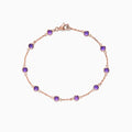 The 14K Rose Gold Amethyst Station Bracelet, 2.45 TCW, features evenly spaced round amethysts and a lobster clasp, shown on a white background.