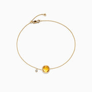 The Sunset 14K Yellow Gold Citrine & Diamond Bolo Chain Bracelet, 1.53 TCW, features a round citrine gemstone and a diamond charm on an adjustable sliding clasp, shown on a white background.