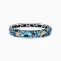 The Seaside Silver and 18K Gold Blue Topaz Starfish Bangle, 26.80 TCW, features clusters of blue topaz gemstones, gold star-shaped accents, and an openwork honeycomb pattern on the inner band.