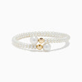 The 14K Yellow Gold Cultured Fresh Water Pearl Wrap Bracelet features small cultured pearls, two larger center pearls, and two yellow gold beads, all showcased on a white background.