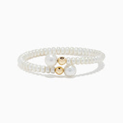 The 14K Yellow Gold Cultured Fresh Water Pearl Wrap Bracelet features small cultured pearls, two larger center pearls, and two yellow gold beads, all showcased on a white background.