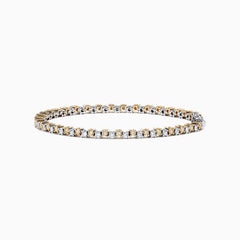 The 14K Two Tone Gold Yellow and White Diamond Tennis Bracelet, 4.30 TCW, features a continuous row of sparkling diamonds in alternating yellow and white gold links, displayed against a white background.