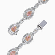 18K two-tone gold bracelet featuring GIA certified pink diamonds (5.39 TCW) in oval and marquise shapes, accented by small clear stones and detailed filigree on the sides.