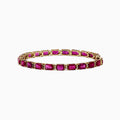 A 14K yellow gold bracelet set with rubies and diamonds, totaling 14.97 TCW, arranged in an elegant tennis style.