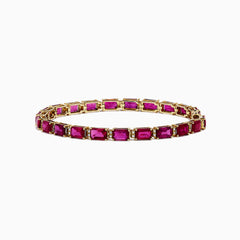 A 14K yellow gold bracelet set with rubies and diamonds, totaling 14.97 TCW, arranged in an elegant tennis style.
