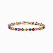 The 14K Yellow Gold Multi Sapphire and Diamond Bracelet (11.16 TCW) features a single row of round sapphires in blue, green, pink, and yellow hues, accented with diamonds and finished with a secure clasp.