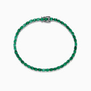 The 925 Sterling Silver Emerald Tennis Bracelet, 6.99 TCW, features a single row of round-cut green gemstones set in sterling silver with a secure clasp, shown elegantly on a white background.