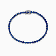 The 925 Sterling Silver Blue Sapphire Tennis Bracelet, 6.99 TCW, features evenly spaced round blue sapphires set in a slender sterling silver band and is finished with a secure clasp.