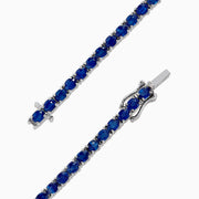 The 925 Sterling Silver Blue Sapphire Tennis Bracelet, 6.99 TCW, features evenly spaced round blue sapphires set in a slender sterling silver band and is finished with a secure clasp.