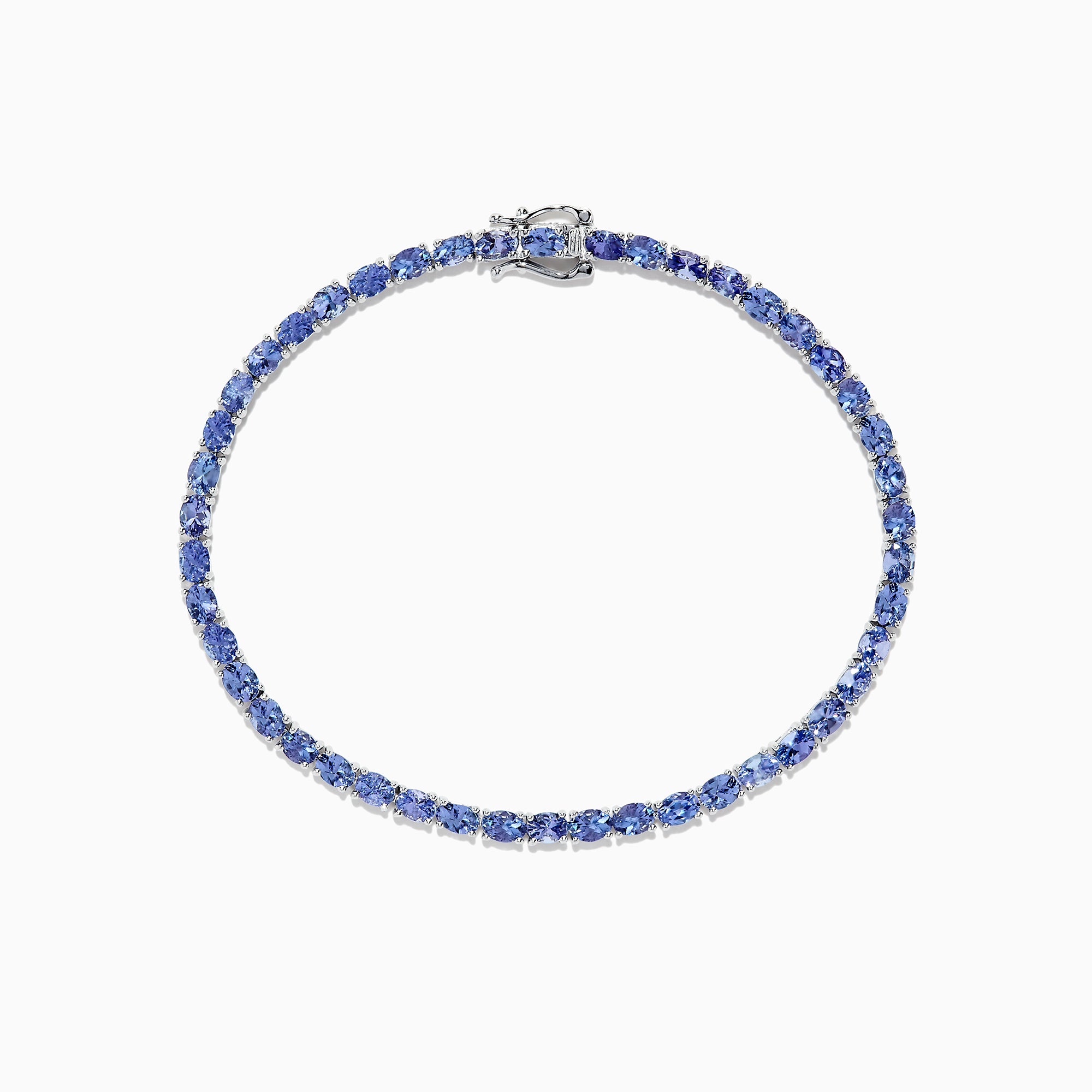 The Nahla Siri Sterling Silver Tanzanite Tennis Bracelet, 6.65 TCW, features oval-cut blue stones in a circular design, set in elegant sterling silver and shown on a white background.