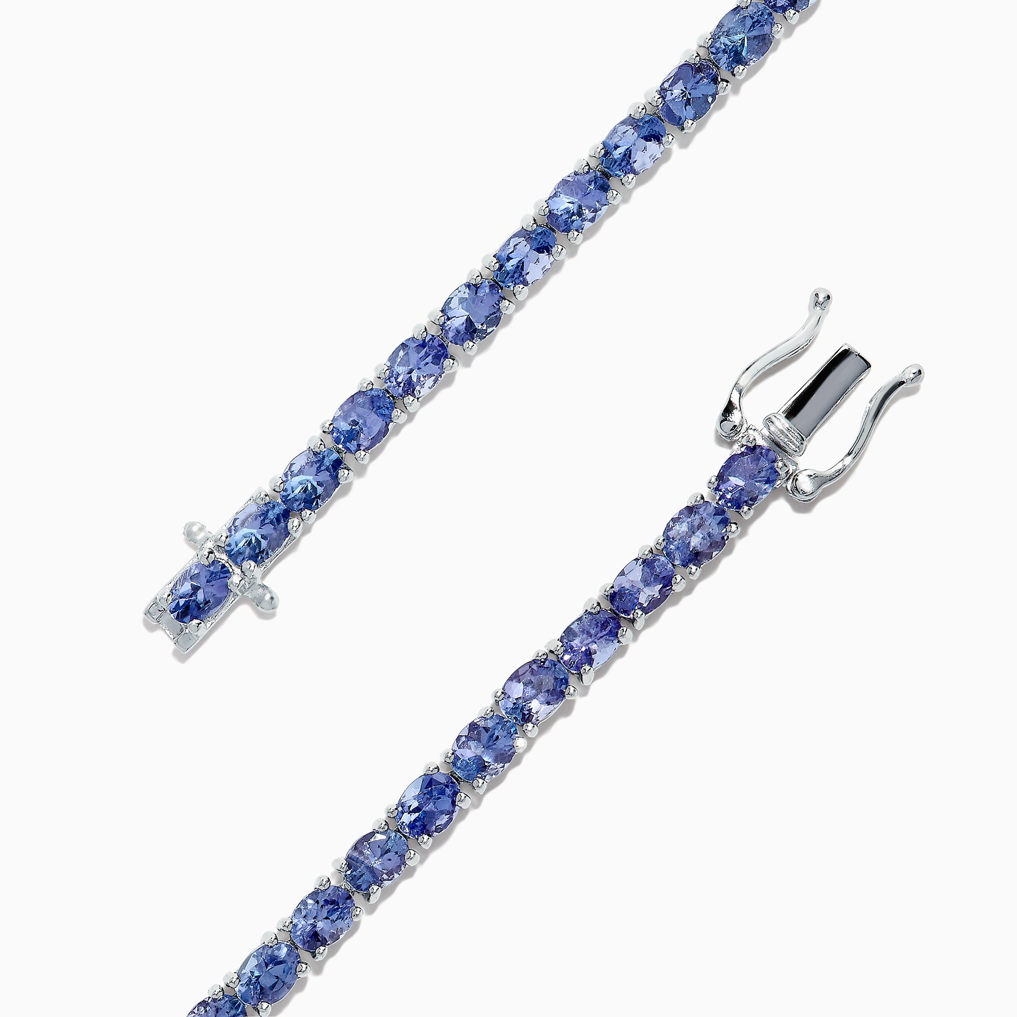 The Nahla Siri Sterling Silver Tanzanite Tennis Bracelet, 6.65 TCW, features oval blue gemstones and a secure clasp, showcasing elegant design and reliable fastening.