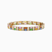 The Watercolors 14K Gold Multi Sapphire and Diamond Bracelet, 16.10 TCW, features rectangular blue, pink, green, yellow, and orange sapphires set in a repeating pattern along its length.