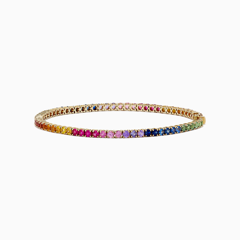 The Watercolors 14K Yellow Gold Multi Sapphire Tennis Bracelet, 5.51 TCW, features a continuous row of rainbow gradient sapphires set in yellow gold, elegantly displayed on a plain white background.
