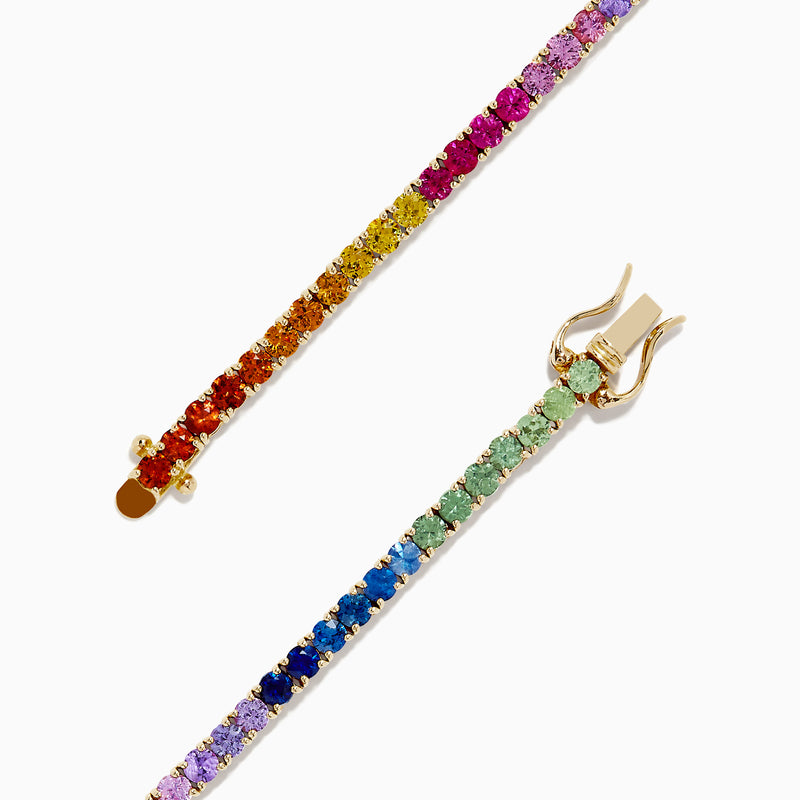 The Watercolors 14K Yellow Gold Multi Sapphire Tennis Bracelet, 5.51 TCW, features a continuous row of rainbow gradient sapphires set in yellow gold, elegantly displayed on a plain white background.