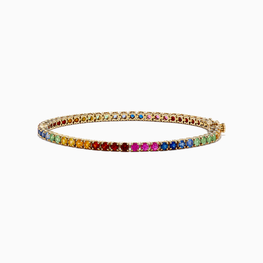 The Watercolors 14K Yellow Gold Multi Sapphire Tennis Bracelet showcases a vibrant rainbow of sapphires in a continuous row, displayed on a white background.