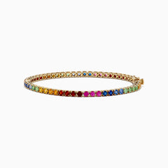 The Watercolors 14K Yellow Gold Multi Sapphire Tennis Bracelet showcases a vibrant rainbow of sapphires in a continuous row, displayed on a white background.