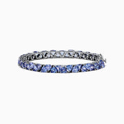 The Nahla Siri Sterling Silver Tanzanite Tennis Bracelet, 18.62 TCW, features a row of square-cut tanzanite gemstones in individual prongs and a secure clasp for an elegant, polished look.