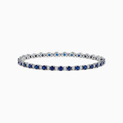 The Royale Bleu 14K Gold Sapphire and Diamond Tennis Bracelet, 4.24 TCW, showcases alternating round blue sapphires and diamonds, elegantly displayed on a white background.