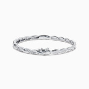The 925 Sterling Silver Diamond Bangle features an elegant twisted design with alternating smooth sections and sparkling diamond accents.