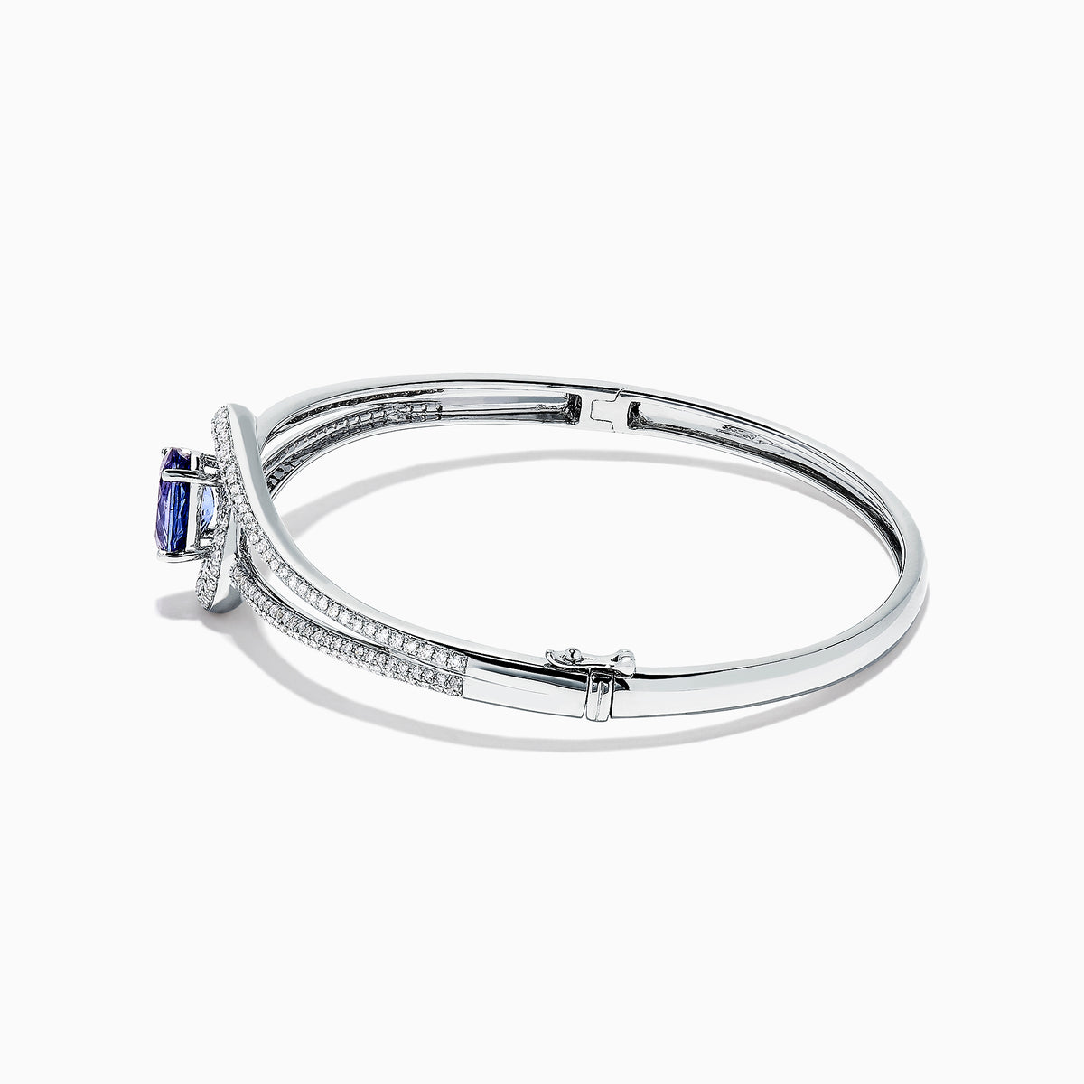 The Nahla Siri 14K White Gold Tanzanite and Diamond Bangle, 2.61 TCW, showcases a central round tanzanite gemstone encircled by sparkling diamonds on a sleek, open band design.