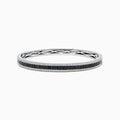 The 14K White Gold Black and White Diamond Bangle, 3.93 TCW, showcases a row of black diamonds at the center with intricate edge detailing, presented against a white background.
