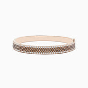 The 14K Rose Gold Espresso and White Diamond Bangle features rows of sparkling espresso brown and white diamonds, beautifully showcased against a plain white background.
