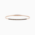 The 14K Rose Gold Espresso Diamond Bangle features a slim, polished design with a row of dark espresso diamonds set along the front for a minimalist, elegant look.