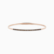 The 14K Rose Gold Espresso Diamond Bangle features a slim, polished design with a row of dark espresso diamonds set along the front for a minimalist, elegant look.