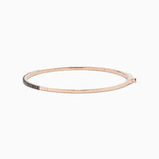 The 14K Rose Gold Espresso Diamond Bangle features a slim, polished design with a row of dark espresso diamonds set along the front for a minimalist, elegant look.