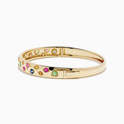 The Watercolors 14K Yellow Gold Multi Sapphire Bangle features sapphires in pink, green, blue, and yellow shades arranged in a scattered design around the band.
