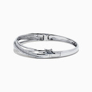 The 14K White Gold Diamond Cross Over Bangle, 1.05 TCW, features intertwined bands with dazzling diamonds, beautifully displayed on a white background.