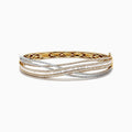 The Duo 14K Two Tone Gold Diamond Crossover Bangle features an intricate overlapping wave design with sparkling diamonds totaling 3.15 TCW, set in both yellow and white gold.