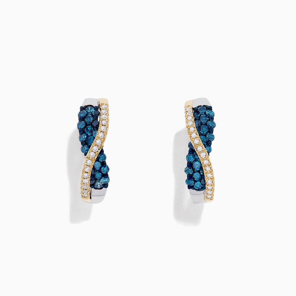 The 14K Two Tone Gold Blue and White Diamond Crossover Hoop Earrings, 1.00 TCW, feature a wavy crossover design with blue and white diamond clusters on one side and a line of small clear stones, shown against a white background.