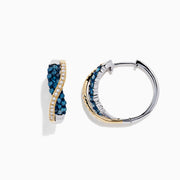 The 14K Two Tone Gold Blue and White Diamond Crossover Hoop Earrings, 1.00 TCW, feature a wavy crossover design with blue and white diamond clusters on one side and a line of small clear stones, shown against a white background.