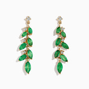 The Brasilica 14K Yellow Gold Emerald and Diamond Drop Earrings feature alternating marquise emeralds and round diamonds in a leaf-and-flower motif, displayed on a white background.