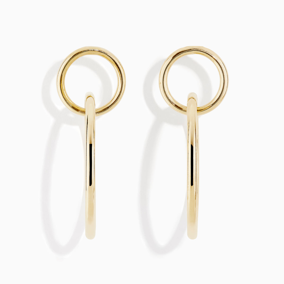 A pair of 14K Gold Interlock Tube Earrings, each with two interlocking circles, displayed against a white background.