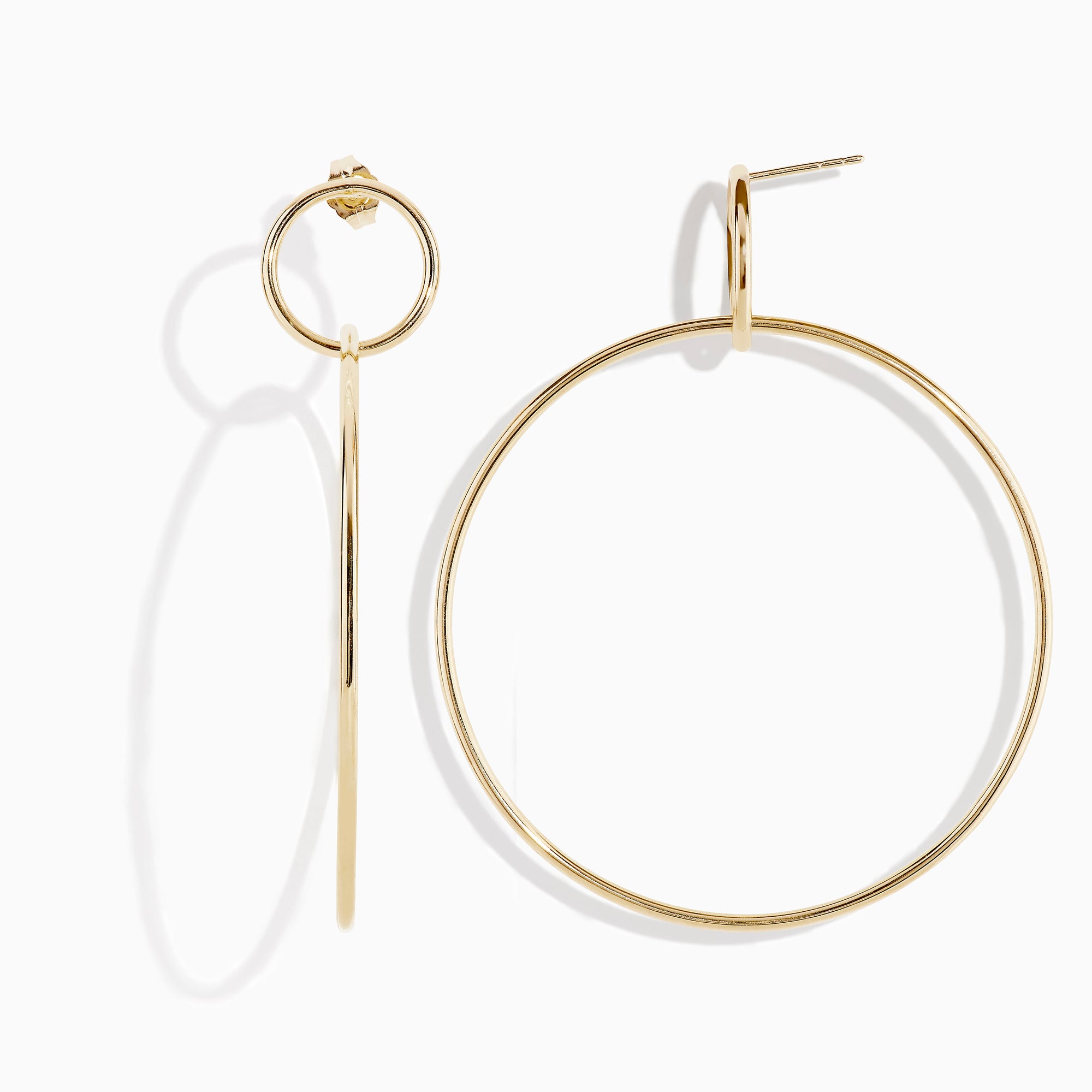 A pair of 14K Yellow Gold Double Circle Drop Earrings, one shown from the side and the other from the front, both displaying minimalist circular designs against a white background.