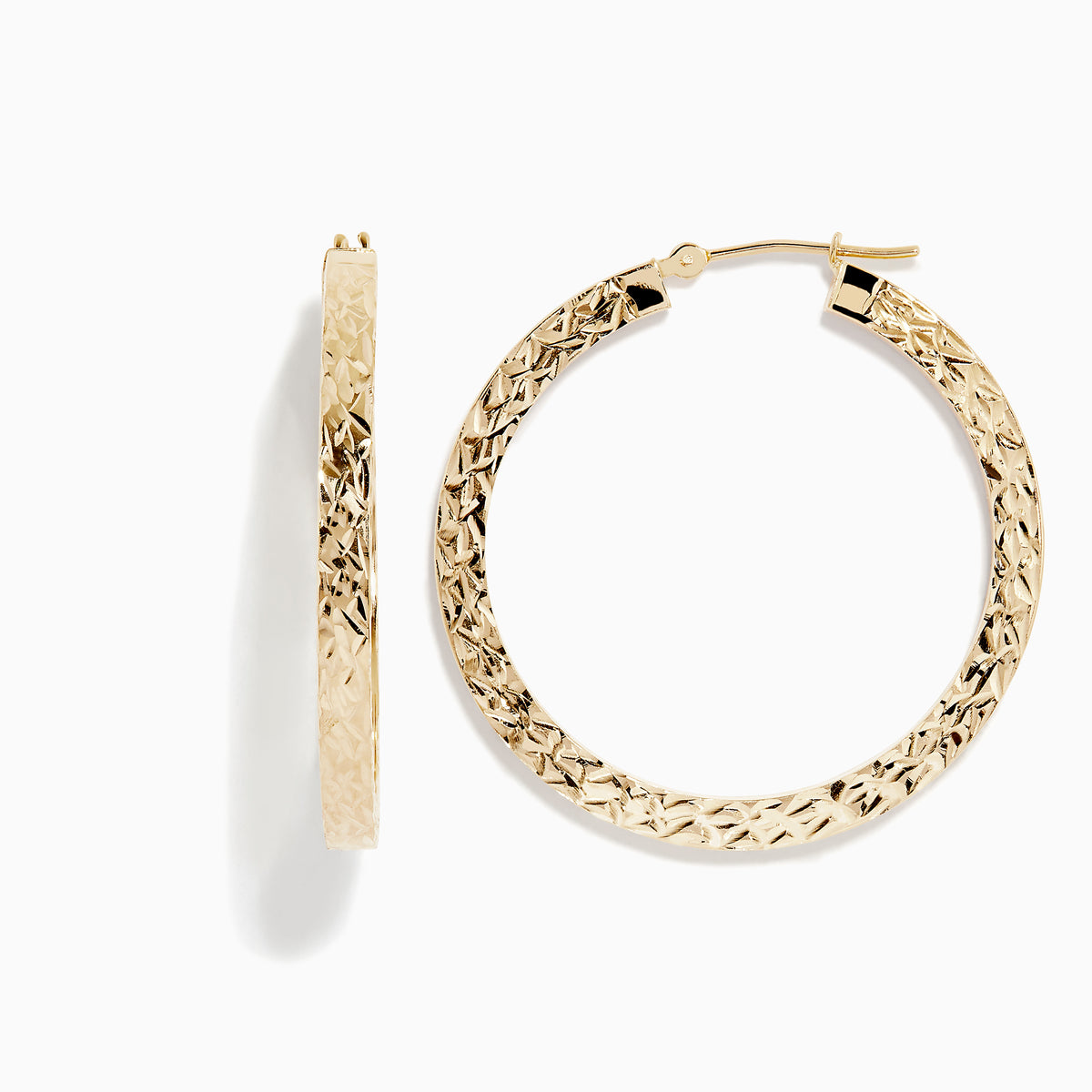 The 14K Yellow Gold Tube Hoop Earrings feature a diamond-patterned, textured surface, latch closures, and are shown with one earring from the front and one from the side.
