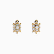 14K yellow gold stud earrings in a turtle shape with multi diamonds and mother of pearl shells, displayed on a white background.
