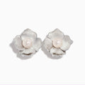 The 925 Sterling Silver Cultured Fresh Water Pearl Flower Earrings feature textured silver petals and a round freshwater pearl at each center, shown on a white background.