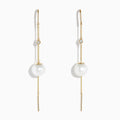 The 14K Yellow Gold Pearl and Diamond Drop Earrings feature a single white pearl and round diamond on each, accented with thin gold chains and bars.