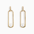 The 14K Yellow Gold Paperclip Cultured Freshwater Pearl Earrings feature elongated oval hoops in yellow gold, each adorned with a single freshwater pearl at the bottom, displayed on a plain white background.